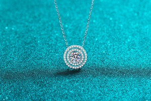 Macro view of S925 silver necklace featuring a double circle pendant and moissanite stone