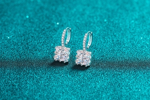 Macro view of princess cut moissanite earrings with 925 silver pave hoop details