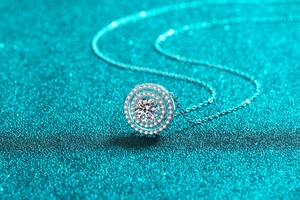 Macro shot of double circle S925 silver necklace with sparkling moissanite pendant