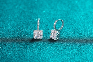 Macro shot of S925 sterling silver hoop earrings with square-cut moissanite stones