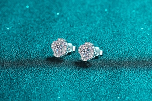 Macro shot of S925 silver hexagonal moissanite stud earrings with a sparkling halo finish