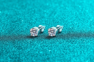 Macro shot of 925 sterling silver four-claw moissanite stud earrings with screw backs