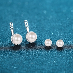 S925 sterling silver moissanite and freshwater pearl earring set on a blue glitter background