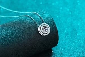 Macro detail of S925 silver necklace with double circle moissanite pendant on dark stand