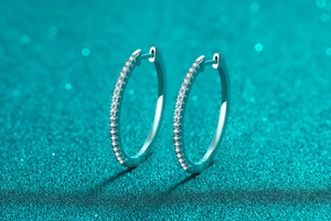 Detailed view of silver S925 sterling silver hoop earrings with sparkling moissanite stones