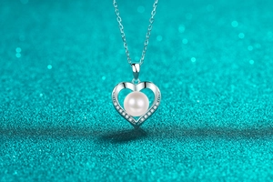 Macro shot of S925 silver heart necklace with a round pearl and sparkling accent stones