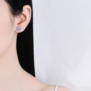 Elegant S925 sterling silver snowflake earrings with moissanite on a female model