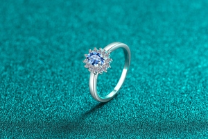 Macro detail of S925 silver ring featuring blue moissanite surrounded by small diamonds