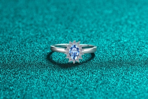 Macro shot of S925 silver ring featuring an oval blue moissanite in a halo setting