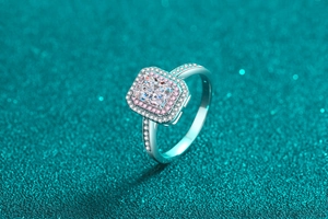 Detail view of radiant emerald cut moissanite ring with double pink and white halo