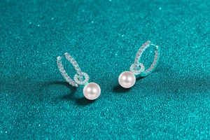 Macro detail of S925 sterling silver drop earrings with freshwater pearls and moissanite