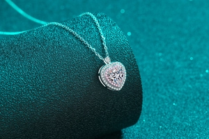 Makroaufnahme eines S925 Silber-Herzanhängers mit Moissanit und rosa Hal Fassung