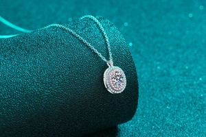 Macro detail of oval moissanite pendant with pink halo on S925 sterling silver chain
