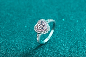 Makro-Detail des silbernen Herzrings mit 1 Karat Moissanit und rosa Pavé-Verzierungen