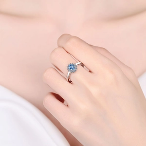 Elegant S925 sterling silver ring featuring a blue moissanite sunflower design on a finger