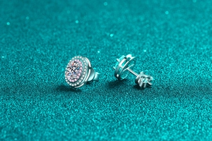 Detailed macro view of 925 silver oval moissanite stud earrings with pink diamond halo