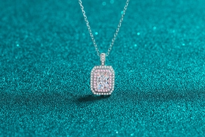 Macro shot of rectangular moissanite pendant with pink and white halo on S925 silver chain