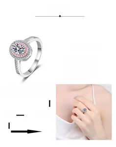 Macro shot of oval Moissanite ring with pink halo and platinum plated 925 silver band
