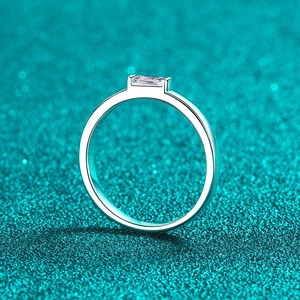 Elegant S925 sterling silver ring featuring an emerald cut moissanite on a teal background