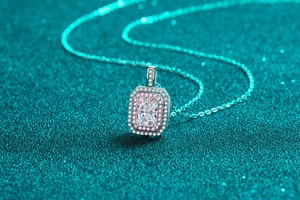 Close-up of S925 silver necklace featuring a double halo rectangular emerald-cut stone