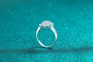 Detail of S925 silver ring featuring a rectangular moissanite stone and pink halo setting