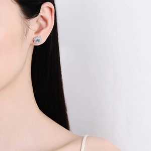 Classic round halo moissanite stud earrings in 925 sterling silver worn by model