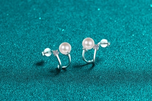 Detailed close-up of S925 silver U-shaped earrings with freshwater pearls and moissanite stones