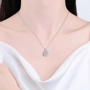 S925 sterling silver necklace with square emerald cut halo pendant on a female model