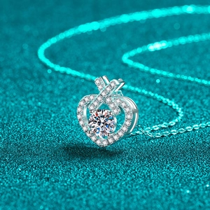 Sparkling S925 sterling silver heart necklace with round moissanite pendant on green base