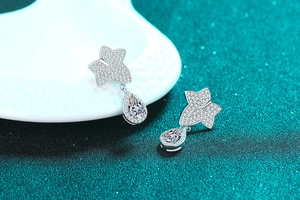 Detailed view of S925 sterling silver maple leaf earrings with pear-cut moissanite stones