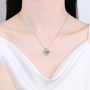 Elegant S925 sterling silver heart necklace with moissanite pendant shown on a model