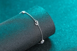 Detail of S925 sterling silver bracelet with number 3 charm and moissanite stone