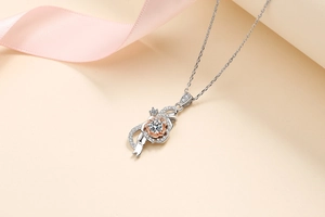 Close-up of two-tone flower pendant with moissanite in a rose and ribbon design