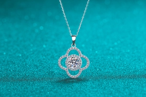 Macro shot of a 925 sterling silver four-leaf flower pendant with a 1ct moissanite stone