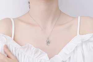 Close-up of S925 sterling silver rose necklace featuring a sparkling moissanite pendant