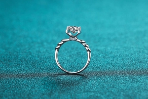 Detailed view of S925 silver moissanite ring with classic four-prong setting and side gems