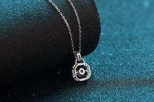 Macro shot of S925 silver necklace featuring a floating round moissanite in a geometric pendant