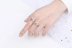 Detail of S925 sterling silver moissanite rings with twisted rope bands on white tulle