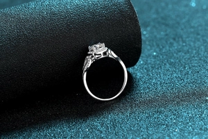 Detailed macro view of S925 silver moissanite ring with halo setting and leaf design