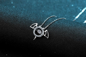 Macro shot of S925 silver bat necklace featuring a dancing moissanite stone detail