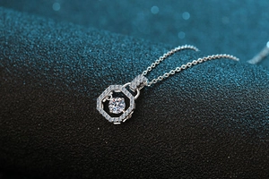 Macro shot of S925 silver hexagonal pendant with pavé diamonds and center moissanite