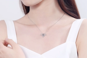 Macro shot of S925 sterling silver devil wing necklace with dancing moissanite stone