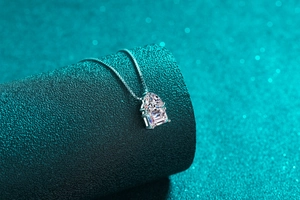 Detailed view of S925 silver necklace with pear and rectangular cut moissanite pendants