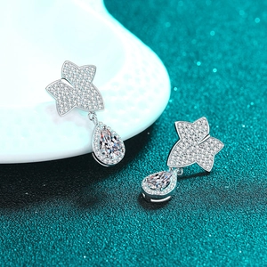 S925 sterling silver leaf drop earrings with moissanite crystals on a glittery background