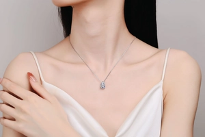Close-up of S925 silver necklace with square cut moissanite pendant on a model