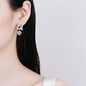 Elegant S925 sterling silver heart earrings with moissanite stones shown on model