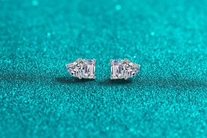 Macro shot of S925 sterling silver studs with heart and emerald-cut moissanite stones