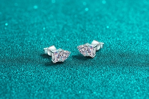 Detailed close-up of S925 silver stud earrings with heart and emerald cut moissanite stones