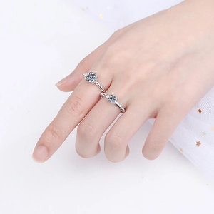 S925 sterling silver moissanite ring with twisted band shown worn on female fingers