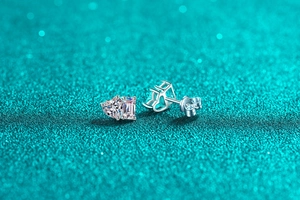 Close-up of S925 silver stud earrings with heart and square cut moissanite stones